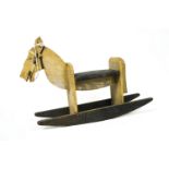 A vintage painted wood rocking horse of simple plank construction,