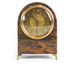 A Continental eight day faux tortoiseshell mantel clock, or arched form, with gilt metal dial,