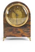 A Continental eight day faux tortoiseshell mantel clock, or arched form, with gilt metal dial,