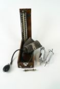 An Accoson blood pressure monitor in mahogany case,