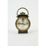 A Swiza eight day heavy brass alarm clock, modelled as a lantern with carrying handle.13cm high.