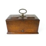 An oak and brass key operated two compartment cigar humidor, with inner hinged covers,