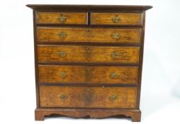 A late Victorian walnut chest of two short and four long graduated drawers