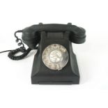 A 1950's black bakelite telephone 6cm high, 27cm wide,