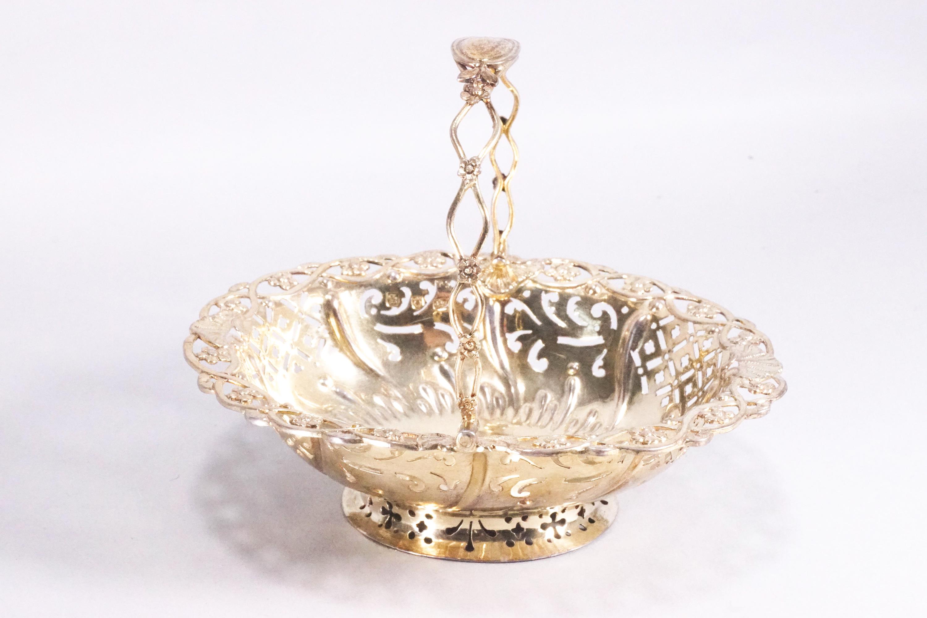 A small silver gilt sweetmeat basket of oval form with pierced panel body