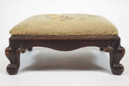 A small mahogany foot stool of square form raised on cabriole legs,