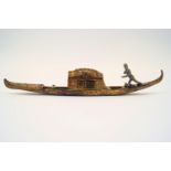 A cold painted and gilt metal inkwell, in the form of a gondola,