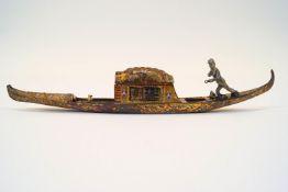 A cold painted and gilt metal inkwell, in the form of a gondola,