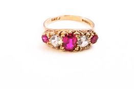 A yellow metal half hoop ring set with synthetic rubies and cubic zirconia.