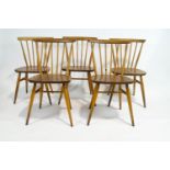 A set of five Ercol beech and elm stick back chairs,
