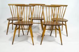 A set of five Ercol beech and elm stick back chairs,