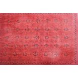 A rectangular carpet of red ground,