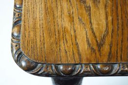 An oak rectangular extending dining table, carved with egg and dart edge,