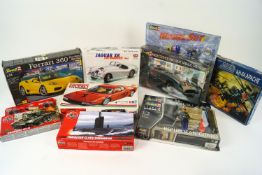 A collection of Airfix, Revell, Tamiya and Burago model kits, including a Jaguar XK 120 roadster,