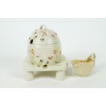 A Belleek honey pot and cover modelled as a domed basket-moulded beehive on a stand,