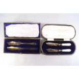 A pair of cased silver and mother of pearl butter knives, of fish knife design, Sheffield 1920,