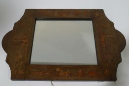 An wood framed mirror, inlaid with figures and stylised foliage,