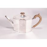 A silver teapot of flat panel octagonal form and domed cover,