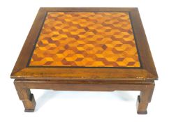 A square Chinese style Coffee table with parquetry top within an ebonised border,