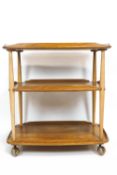 An Ercol light elm drinks/tea trolley, two tier, on casters,