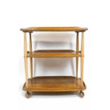 An Ercol light elm drinks/tea trolley, two tier, on casters,