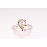 A white metal single stone ring. Illusion set with a pear cut diamond stated to weigh 0.97cts.