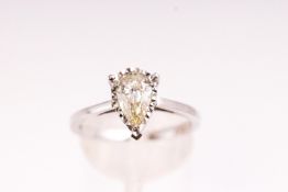 A white metal single stone ring. Illusion set with a pear cut diamond stated to weigh 0.97cts.