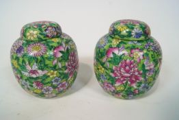 A pair of modern Chinese style green ground ginger jars and covers, a bowl and a plate,