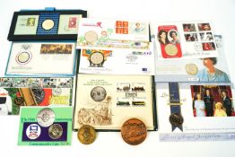 A collection of commemorative coins, medals and stamps,