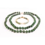 Two strands of nephrite jade beads,