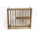 An oak hanging plate rack, of rectangular section, with two rows of turned spindles,