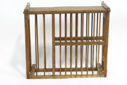 An oak hanging plate rack, of rectangular section, with two rows of turned spindles,