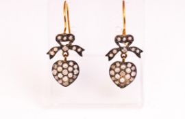 A yellow and white metal pair of drop earrings.