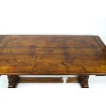 An oak refectory table with triple plank top on two turned baluster supports to either end