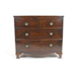 A 19th century mahogany chest of two short and two long drawers with shaped apron on ogee bracket