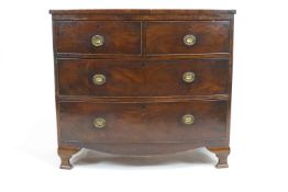 A 19th century mahogany chest of two short and two long drawers with shaped apron on ogee bracket