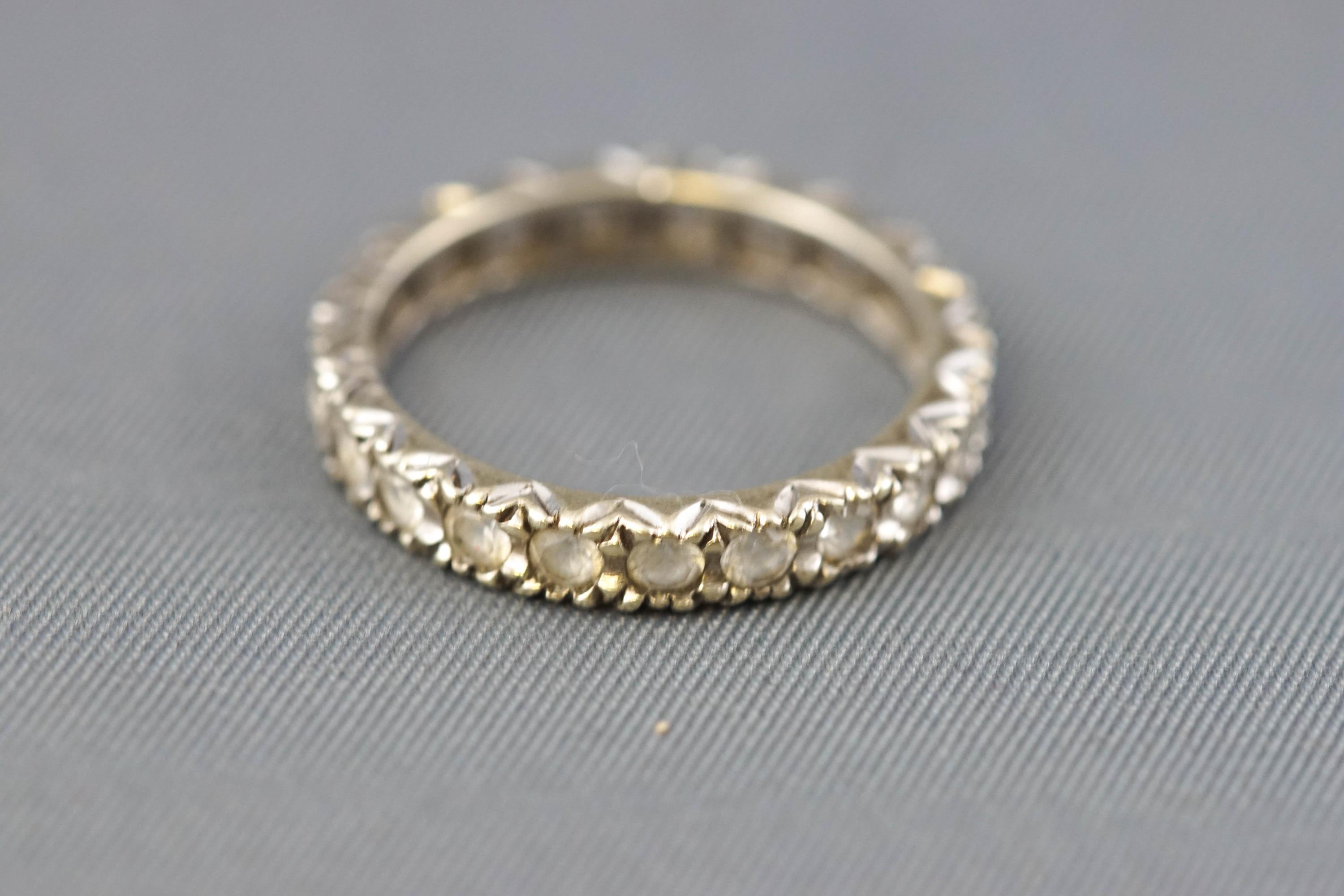 A white metal full eternity ring set with colourless synthetic spinel. - Image 2 of 3
