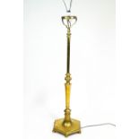 A brass standard lamp base, the stem cast with gadroons above hexagonal stem,