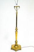 A brass standard lamp base, the stem cast with gadroons above hexagonal stem,