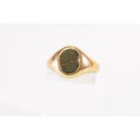 A yellow metal signet ring set with an oval bloodstone. Hallmarked 9ct gold, Birmingham, 1968.