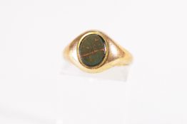 A yellow metal signet ring set with an oval bloodstone. Hallmarked 9ct gold, Birmingham, 1968.