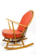 An Ercol light elm Windsor rocking chair, with fitted cushions,