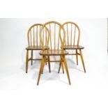 Three Ercol elm and beech dining chairs with Windsor style stick backs,