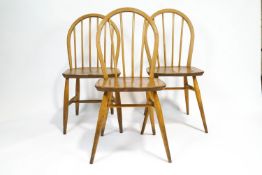 Three Ercol elm and beech dining chairs with Windsor style stick backs,