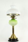 A 19th century brass oil lamp, the opaque glass shade above a pierced burner,