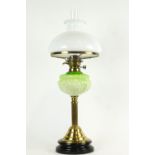 A 19th century brass oil lamp, the opaque glass shade above a pierced burner,