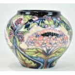 A small Moorcroft ginger jar style vase, with stylised hydrangea decoration on a blue ground,