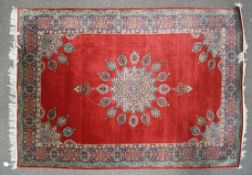 A fine weave Persian style carpet with central medallion issuing multiple medallions on a red ground