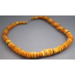 A single strand of honey/yellow graduated beads. Strung plain and finished with a hook clasp.