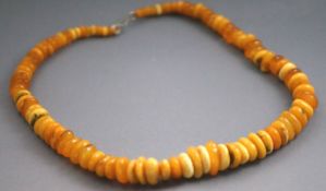 A single strand of honey/yellow graduated beads. Strung plain and finished with a hook clasp.